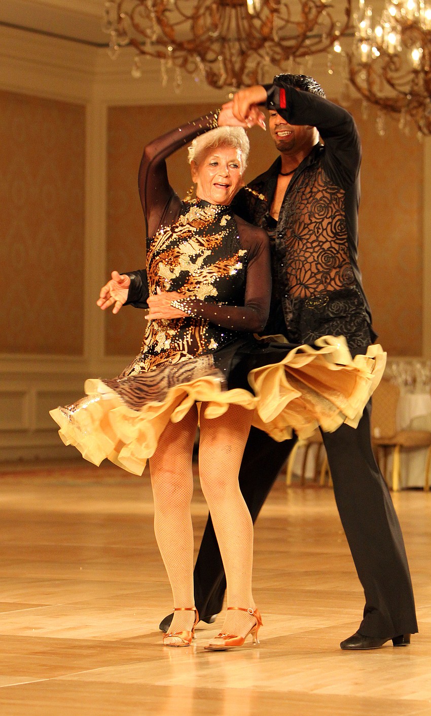 Jeanette Dunstan gets spun around on the dance floor by her partner, Eddie Rivera, Wednesday, August 3 during the Florida State DanceSport Championships at the Ritz Carlton Sarasota.