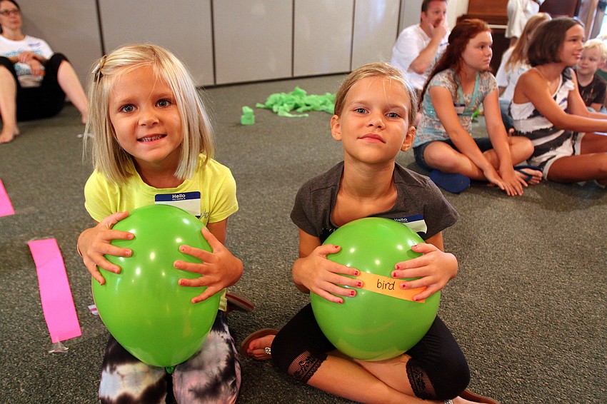 Ava, 4 Â½, and Chloe, 6 Â½, Tesinksy hold onto green ballons Monday, August 8 during vacation bible school at Siesta Key Chapel.