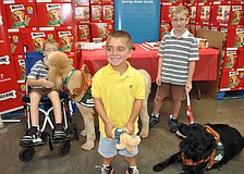 Grayson Tullio, center, has been waiting to get a service dog for two years. Grayson suffers from muscular dystrophy, and now, thanks to a partnership between Milk Bone and Sam's Club, he will be getting a service dog in 2012.