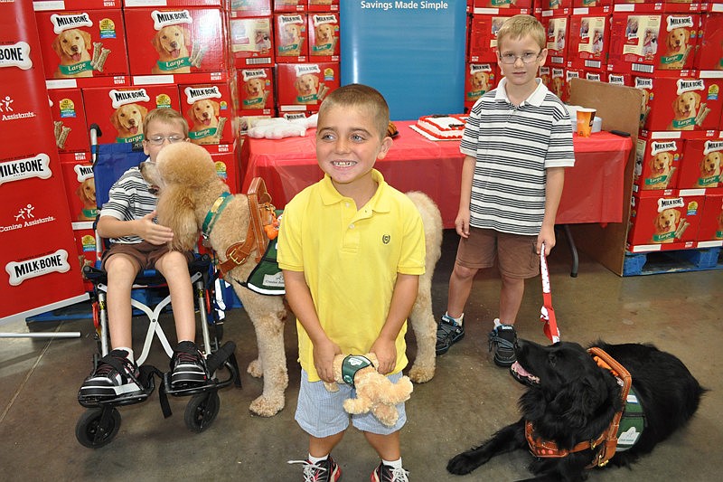 Grayson Tullio, center, has been waiting to get a service dog for two years. Grayson suffers from muscular dystrophy, and now, thanks to a partnership between Milk Bone and Sam's Club, he will be getting a service dog in 2012.