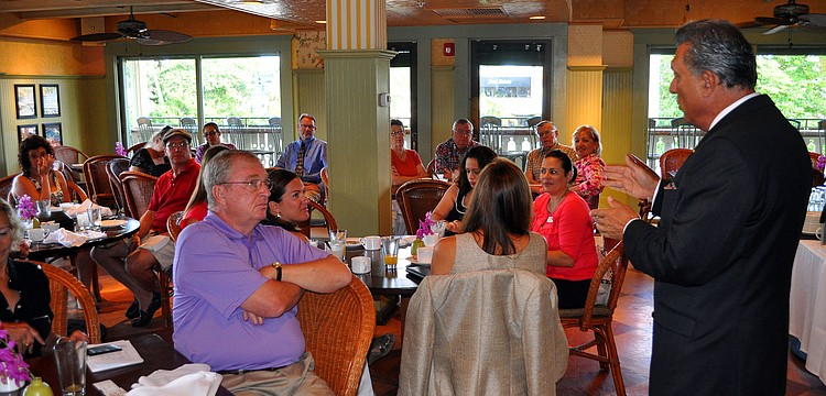 President Andrew Vac speaks to the members of the Circle Association Tuesday, Aug., 16 at Tommy Bahama Restaurant.
