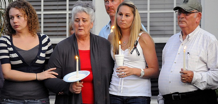Nikki Lay, Carolyn Eason, Keith Steiff, Joann Steiff and Ben Eason mourn the loss of U.S. Army Spc. 4 Patrick Lay II during a candlelight vigil Aug. 15.