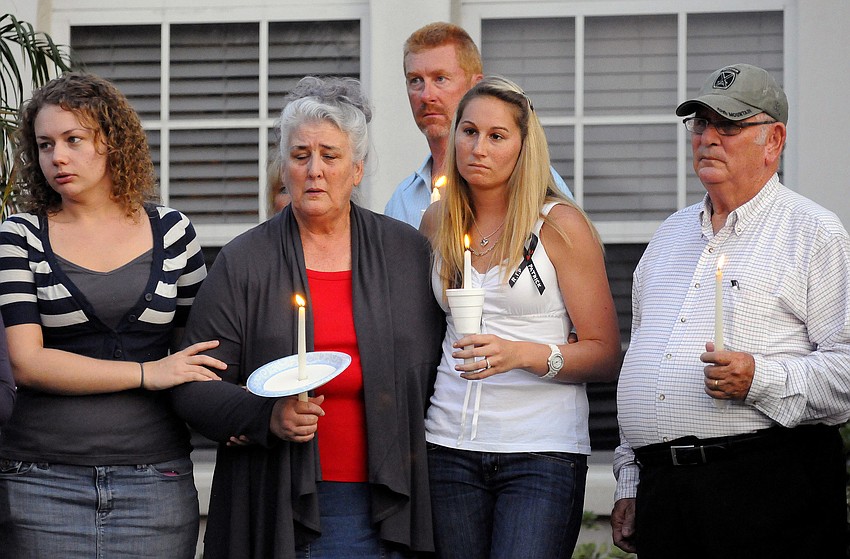 Nikki Lay, Carolyn Eason, Keith Steiff, Joann Steiff and Ben Eason mourn the loss of U.S. Army Spc. 4 Patrick Lay II during a candlelight vigil Aug. 15.