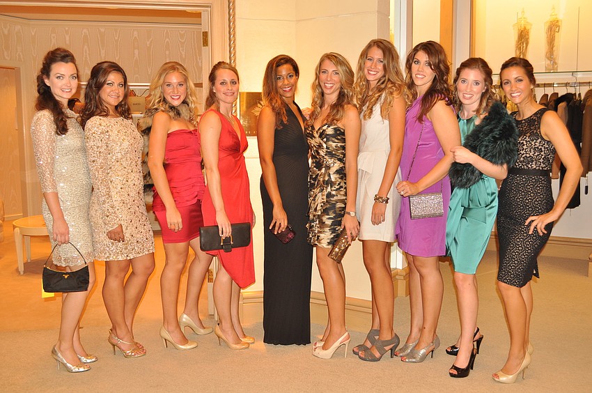 Models pose post fashion show in Saks Fifth Avenue evening wear.