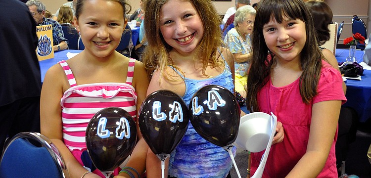 Julianna Maggard, 9, Emma Katz, 9, and Rebekah Steinbeck, 9, performed â€œTomorrowâ€ and â€œDo, re, miâ€ during the Havdalah sing-a-long Saturday, Aug. 20 at Temple Emanu-El.