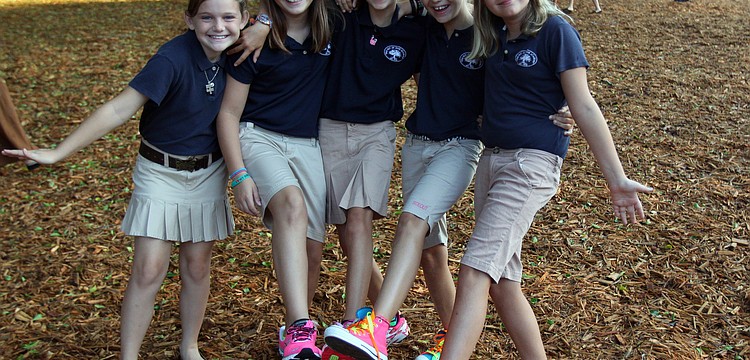 Fifth graders Gracie Schlotthauer, 9, Emma Donato, 10, Hannah Bizick, 10, Caroline Lafoe, 10, and Celia Miller, 10, show off their new, brightly colored shoes.