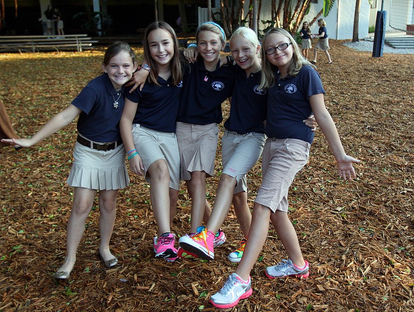 Fifth graders Gracie Schlotthauer, 9, Emma Donato, 10, Hannah Bizick, 10, Caroline Lafoe, 10, and Celia Miller, 10, show off their new, brightly colored shoes.