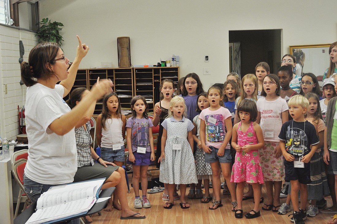 Genevieve Beauchamp leads the campers in song.