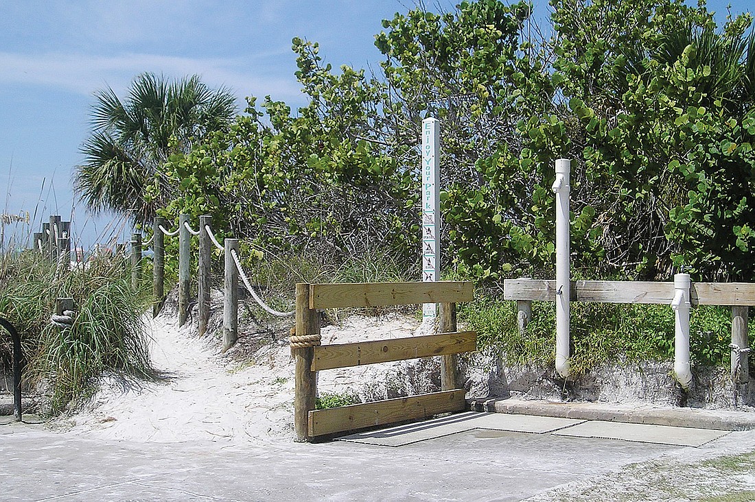 On a sunny day at Siesta Public Beach, the shower area in the northernmost part of the parking lot poses no immediate problems, but rainy days and heavy shower use have produced algae growth in standing water.
