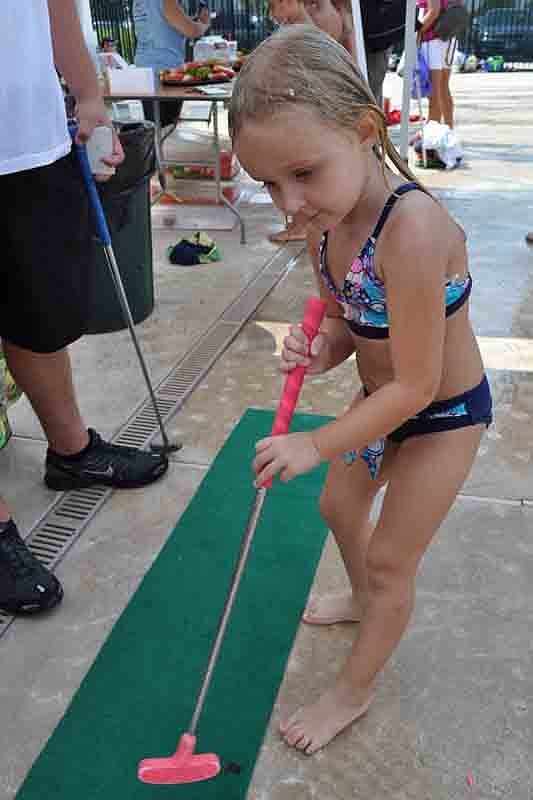 Sierra Lipton, 4, was determined to get the ball in the hole.