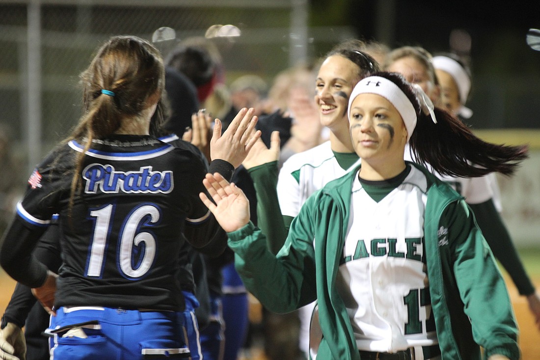 FPC and Matanzas exchange high-fives after Friday's game. The Lady Bulldogs used a six-run first inning to top the Lady Pirates, 8-0. (Photos by Andrew O'Brien)