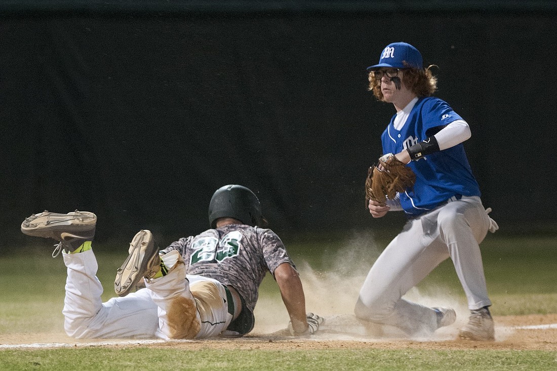 Joseph Bernhard, the starting pitcher, slides in under the tag of Matanzas third baseman Anthony Marco. (Photos by Steven Libby)