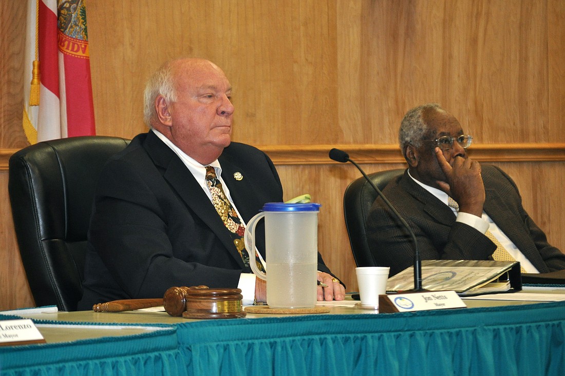 Palm Coast Mayor Jon Netts and Councilman Bill Lewis discuss and interlocal agreement for the city's upcoming elections. (Photo by Jonathan Simmons.)