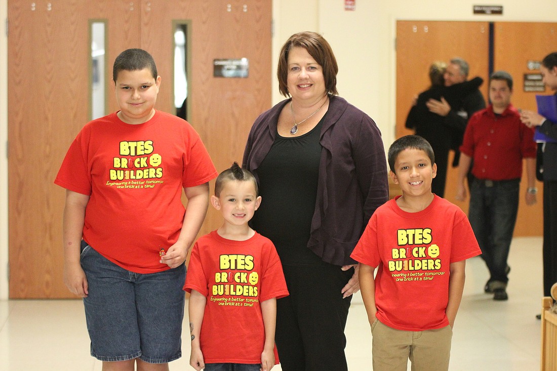 Belle Terre Elementary School teacher Teresa Philips attended the April 1 School Board meeting with a few members of her Brick Builders Club: Jared Anderson, Collin Jones and Alessandro Bevacqua. (Brian McMillan)