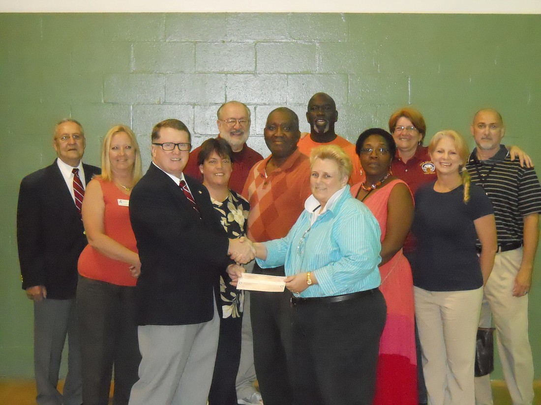 Jerry OÃ¢â‚¬â„¢Gara presents a check to Cheryl Massaro, the G.W. Carver Community Center Director COURTESY PHOTOS