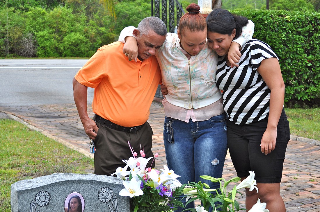 Jose Gonzalez and his granddaughters Teysha Silva-Roman and Keily Silva-Roman unveiled a headstone April 18 for Zuheily Rosado, killed in a shooting at a local gas station last year. (Photo by Jonathan Simmons.)