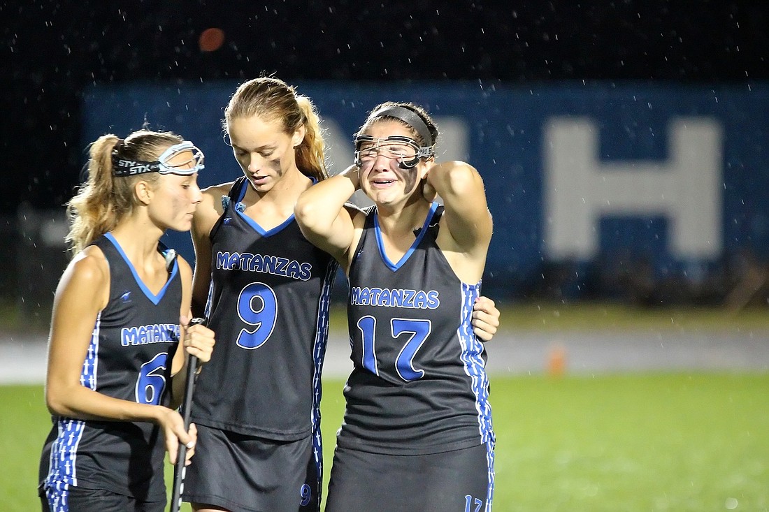 Matanzas senior attacker Sara Komanowski is comforted by teammate Jillian Bontempo (9). (Photo by Joey LoMonaco)