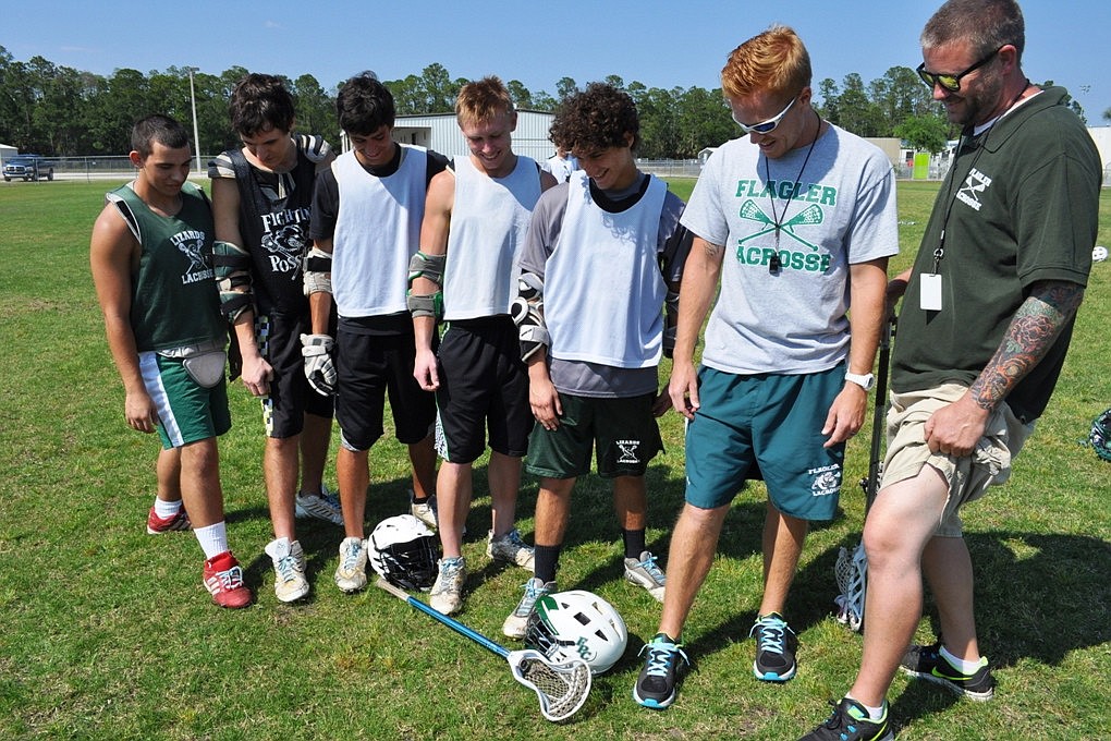 The Flagler Palm Coast High School boys lacrosse team shows off light blue shoelaces worn to promote prostate cancer awareness. (Courtesy photo)