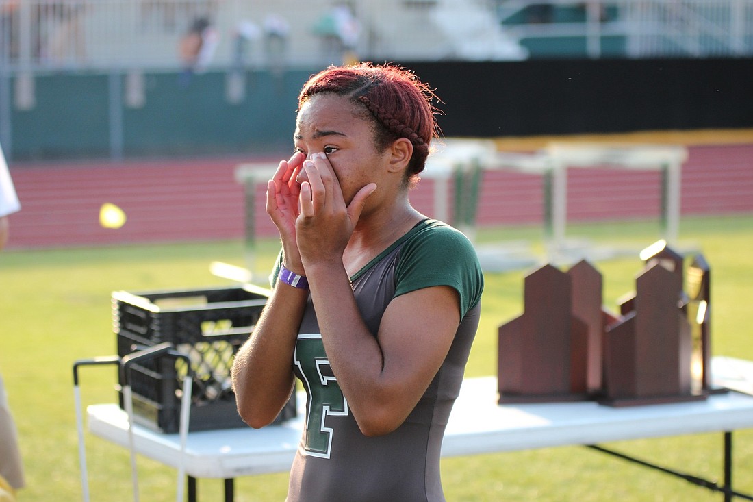 FPC's Ladeijah Williams wipes away tears after fiding out her 4100 relay team finished fourth and is bound for states (Photo by Joey LoMonaco)