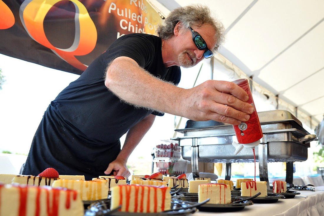 CaptainÃ¢â‚¬â„¢s BBQ owner and chef Michael Goodman puts the finishing touches on cheesecake samples at the VIP kickoff event. PHOTOS BY SHANNA FORTIER