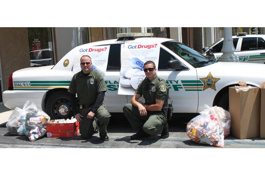 Detective Robert Blanton (left) and Deputy Trevor Jacob assisted with the drug take-back event in Palm Coast. (Photo courtesy of the Flagler County SheriffÃ¢â‚¬â„¢s Office)