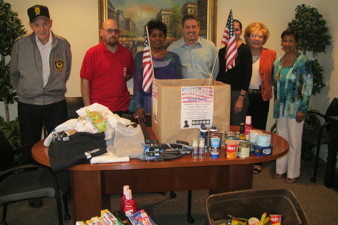 Coldwell Banker Premier Properties, Palm Coast Office Realtor Cathy Heighter-Moore, at center, helped organize the office's efforts for the March 29 Homeless Veterans Stand Down. (Courtesy photo.)