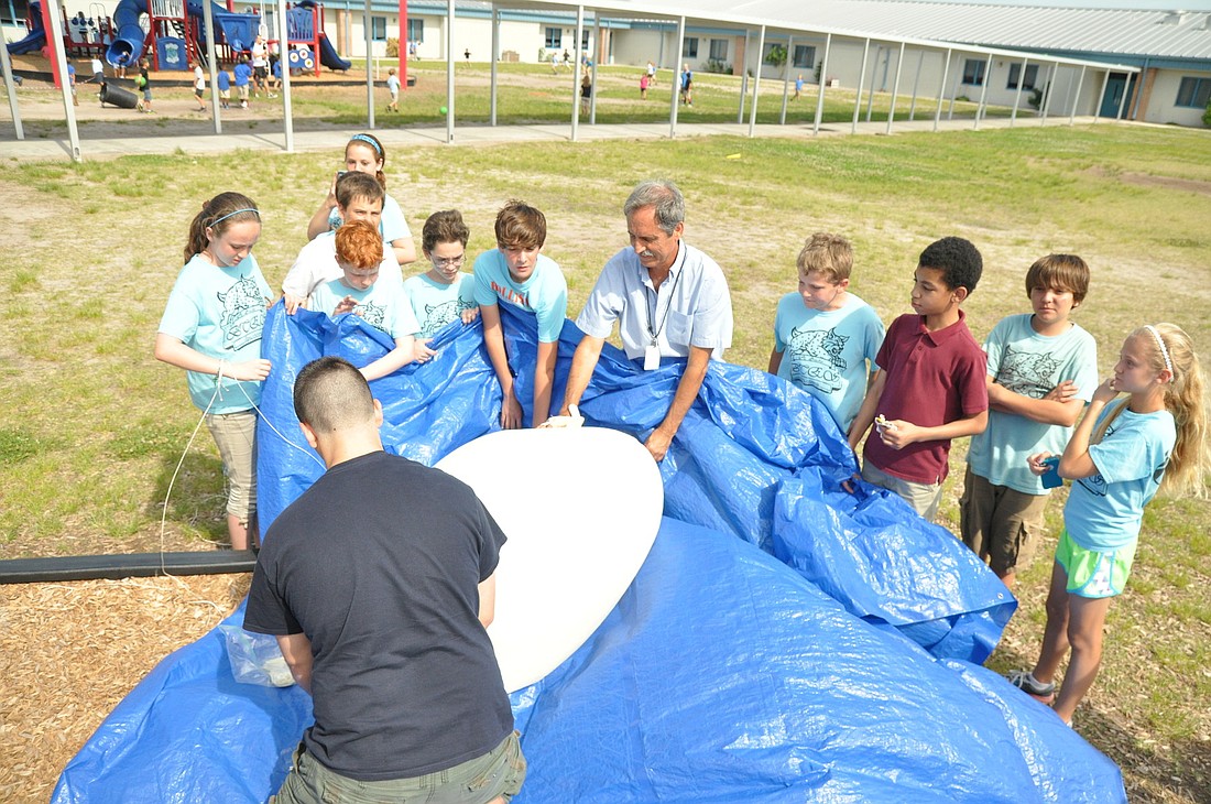Students in the Belle Terre Elementary STEM Club help inflate a tethered weather balloon. PHOTOS BY SHANNA FORTIER