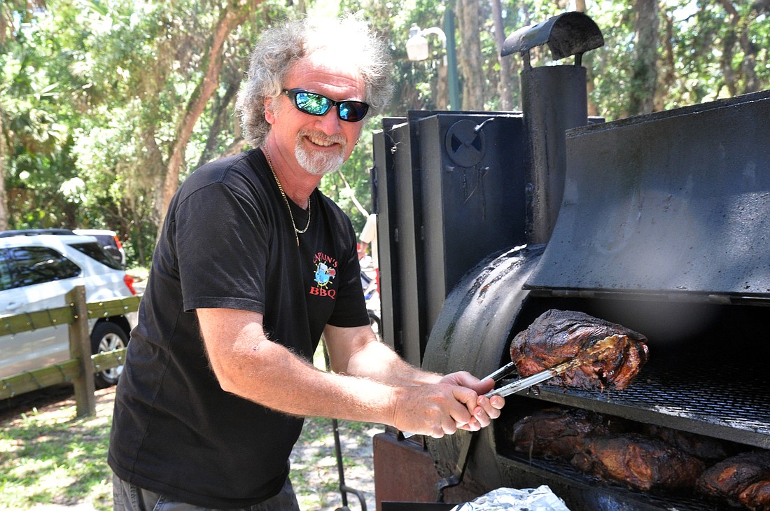 CaptainÃ¢â‚¬â„¢s BBQ owner Mike Goodman shows of meat being cooked to perfection in one of two smokers of grounds.