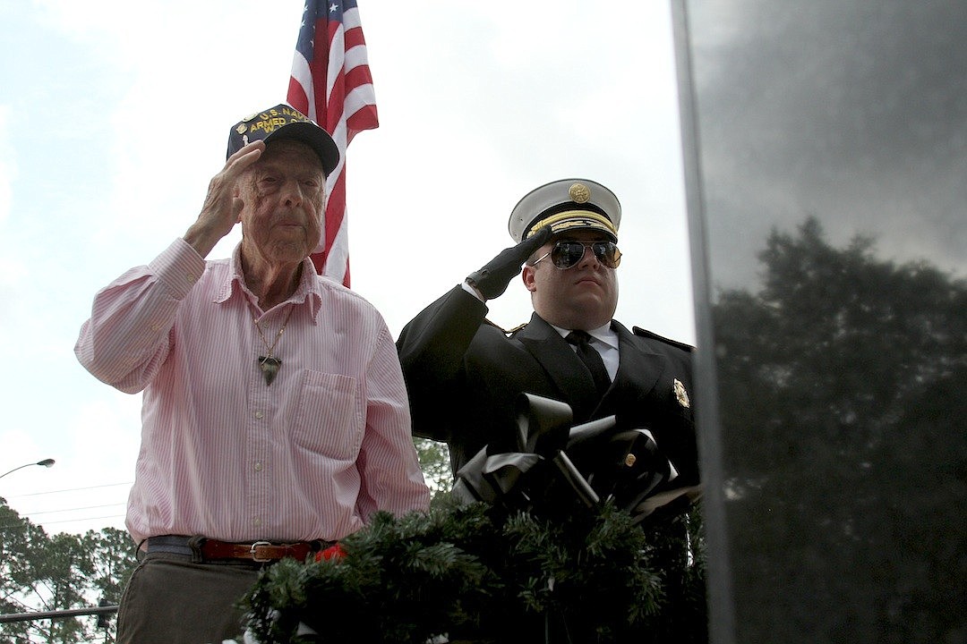 Veteran Frank Hedrick joins Patrick Juliano, of the Palm Coast Fired Department Color Guard, at Heroes Park.