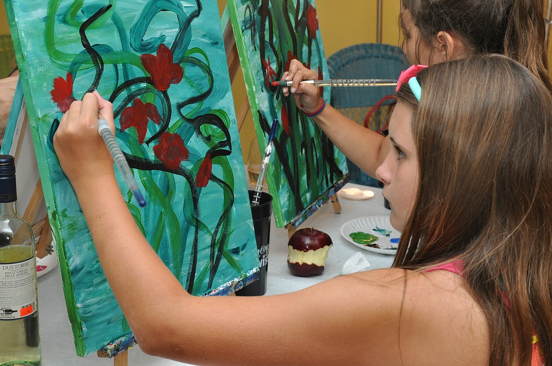Vaden Hughes, 10, concentrates on her painting at the May 28 class. PHOTOS BY SHANNA FORTIER