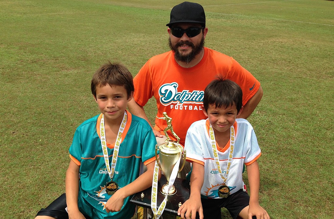 Coach Luis Silva's U10 Dolphins team won the Super Bowl, thanks in part to Landon Gonzalez (left). His U8 Dolphins team also won, thanks in part to Caden Gonzalez (right).