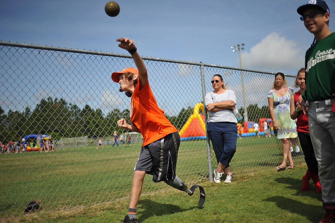 Tyler Jacques, 12, throws at the dunk dank at Saturday's Palm Coast Little League closing ceremonies. (Joey LoMonaco)