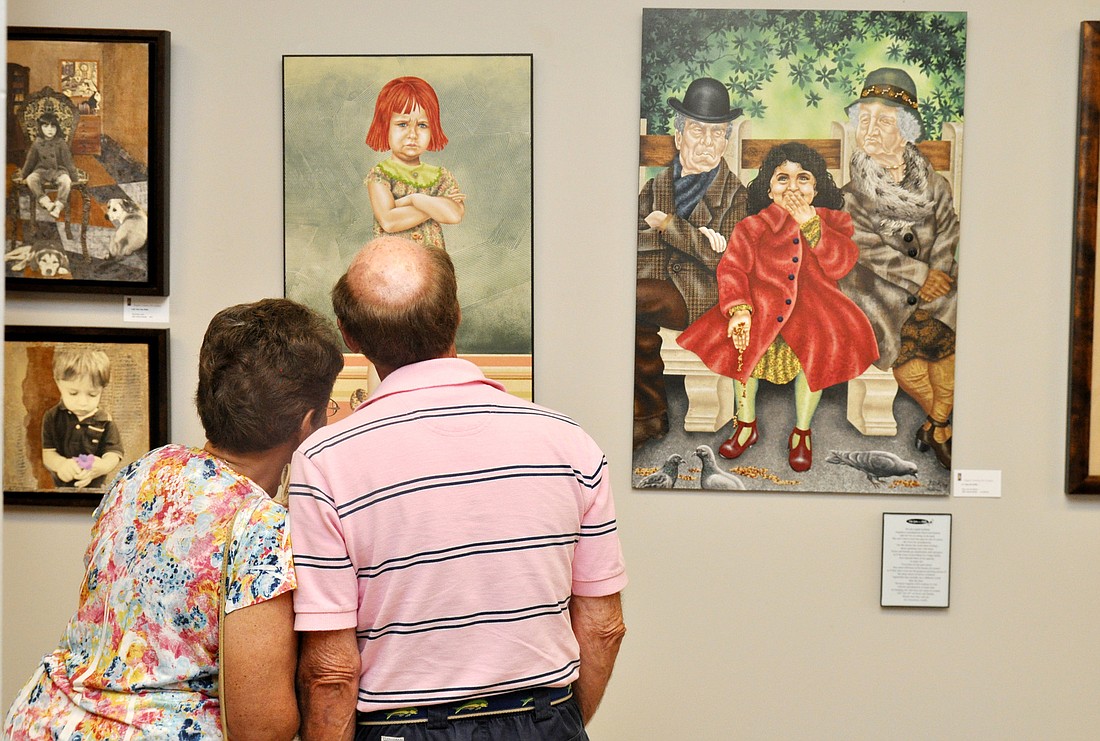 Ileine and Harvey Hoffman  take time to appreciate the art in the Flagler County Art League's new show. PHOTOS BY SHANNA FORTIER
