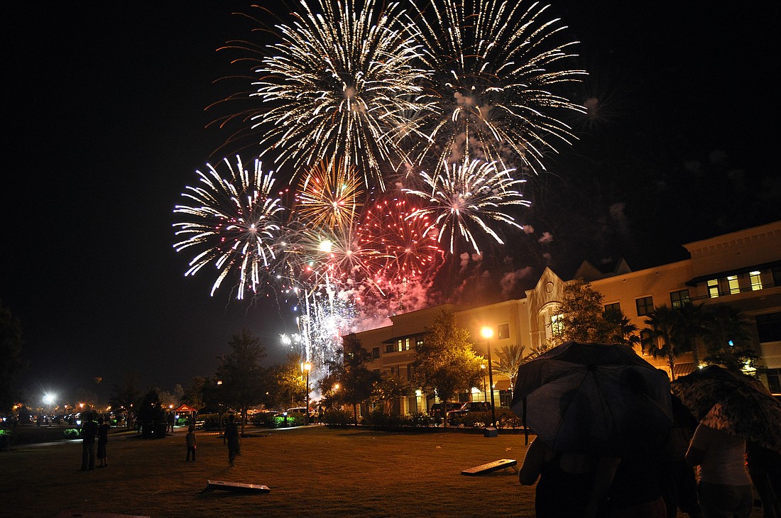 Umbrellas quickly became the perfect accessory for the July 3 firework display in Palm Coast's Town Center. PHOTOS BY SHANNA FORTIER