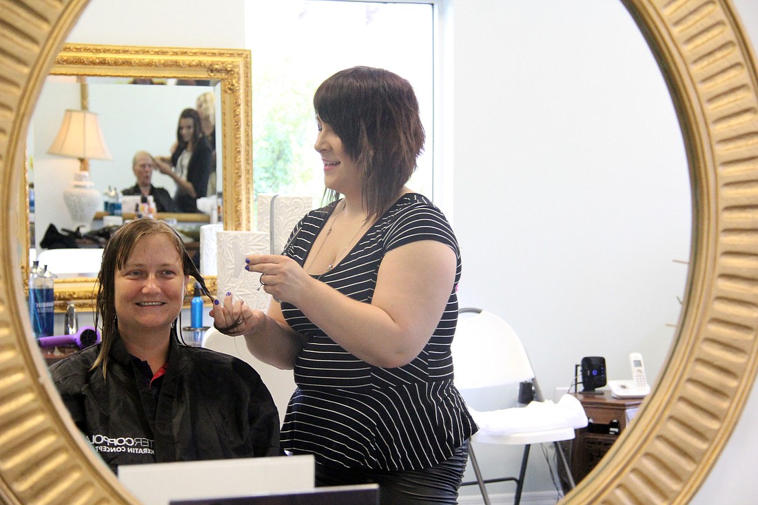 Survivor Karen Dean is eager for a hairstyle change and stylist Elizabeth Davis is giving it to her. PHOTOS BY SHANNA FORTIER