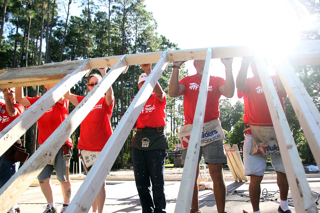Volunteers raise the walls on Flagler Habitat for HumanityÃ¢â‚¬â„¢s 84th home the morning of Sept. 11. PHOTOS BY SHANNA FORTIER
