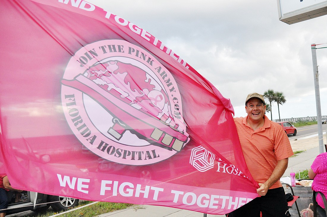 Ken Tarsitano flies the Pink Army flag in front of the Flagler Beachfront Winery. PHOTOS BY SHANNA FORTIER