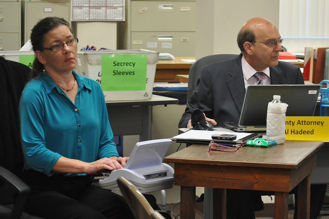 Court reporter Mary Graybosch and County Attorney and Canvassing Board Attorney Al Hadeed at a Canvassing Board meeting Oct. 29. (Photo by Jonathan Simmons)