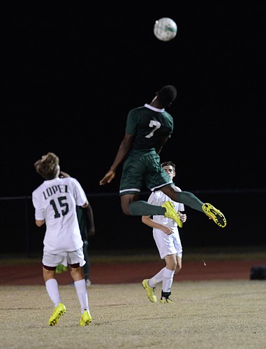 Stanley Joseph jumps over two Father Lopez defenders to win a header in the Bulldogs win.