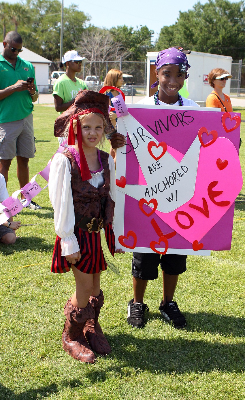 Dana Habedank, 8, and Kaitlyn Sparks, 15,  hold the anchor at the end of the Bank of America paper chain during 2011's Relay for Life on Saturday, April 9 at Sarasota High School.