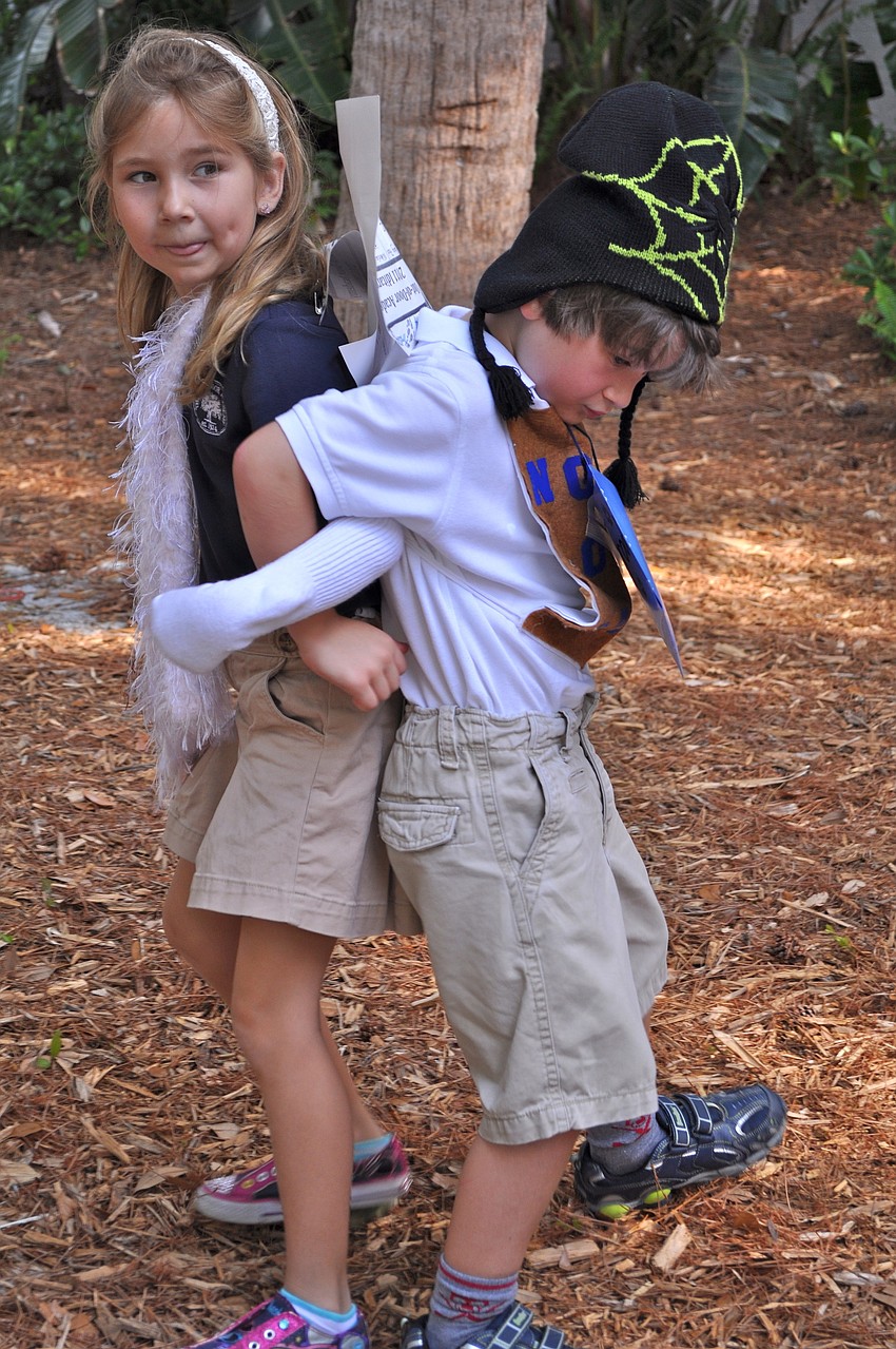 Alexandra Morgan and Tristan Jordan attempt to walk while their arms are linked.