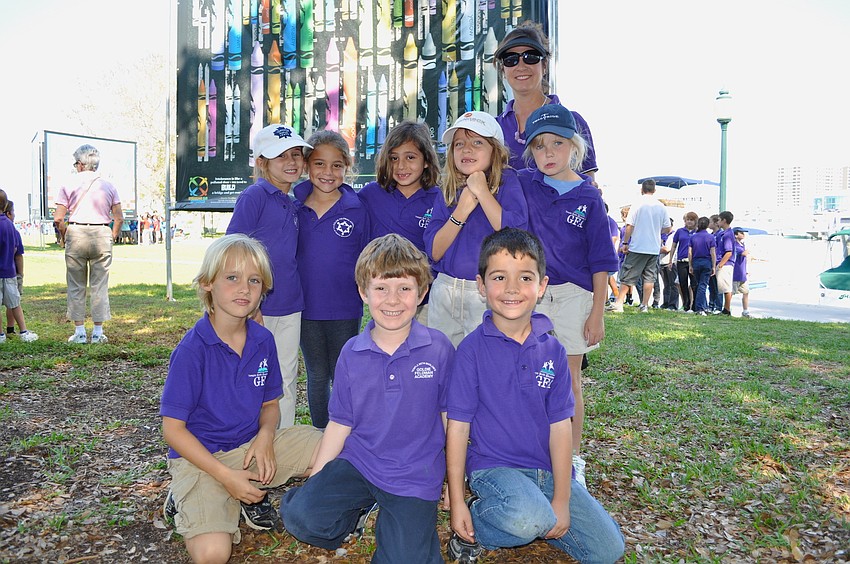Goldie Feldman Academy students stand in front of one of their favorite posters.