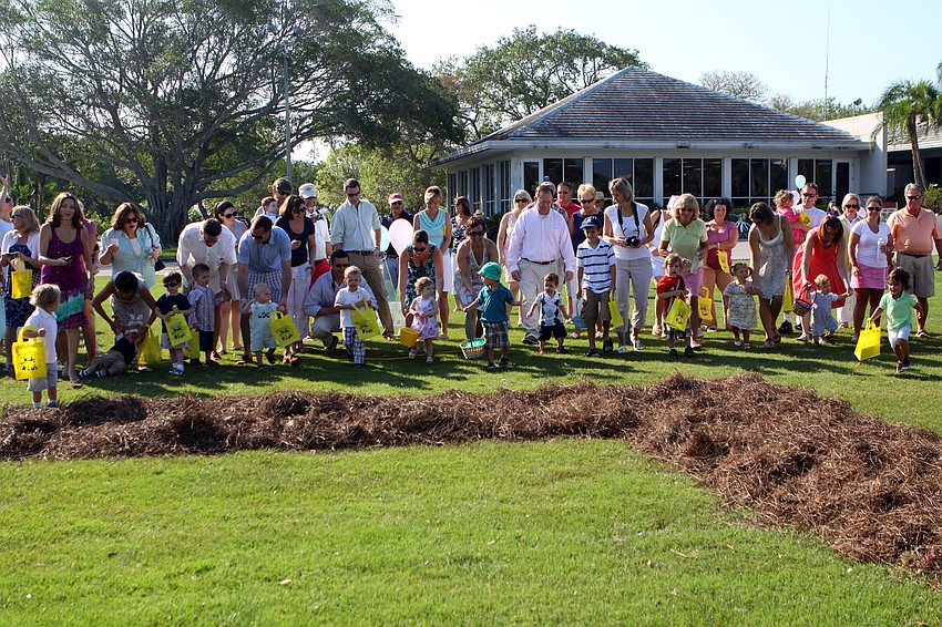 The youngest Easter egg hunters make their way toward the 