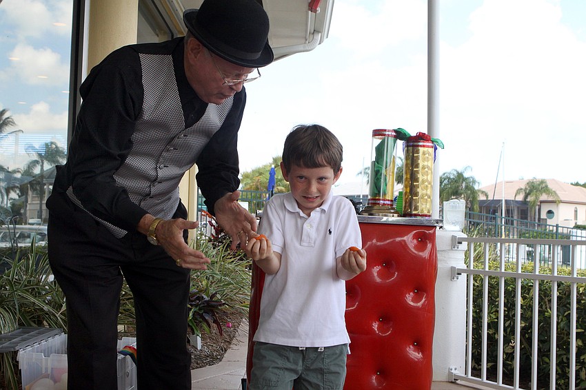 Spencer Martin looks unsure of what to do next during a magic trick with magician Stevie Dee.