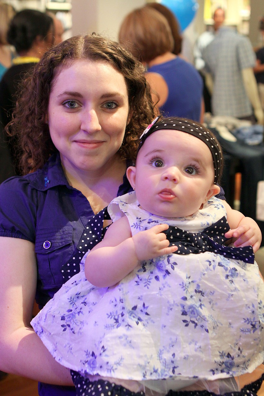 Amanda Ortega holds her daughter, Gabriela, during the Paint the Town Blue event at Westfield Southgate.