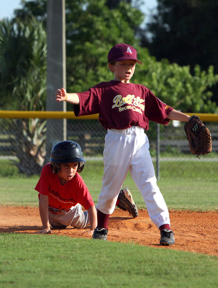 Ricky Jackson, #9, of Ball N Shoe calls out for the ball after Brandon Viera, #1, of the Observer, makes it safely to second base.