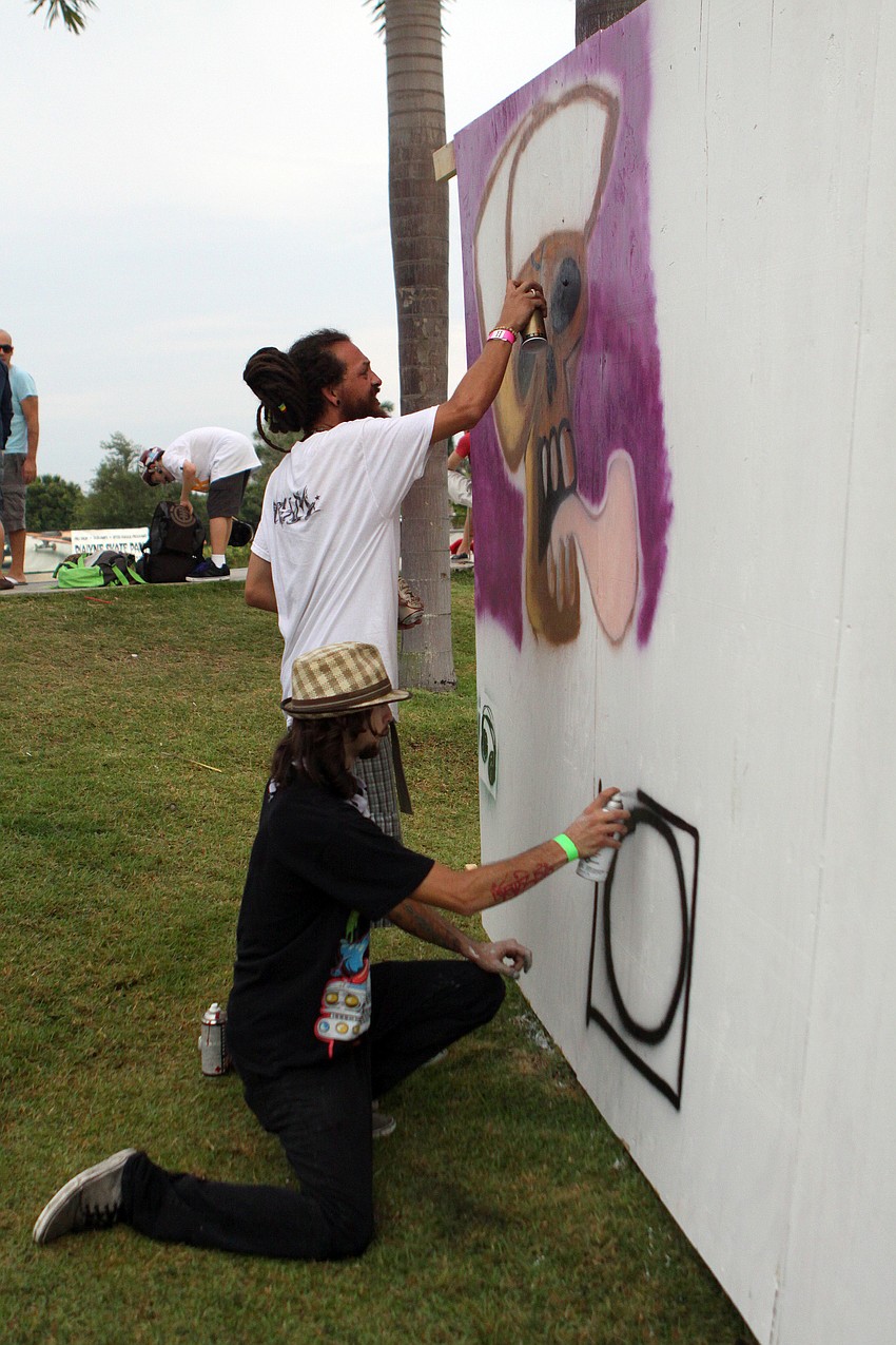 Julian Simon and Jacob Hill start working on their live art Saturday, May 14 during the Golden Era Tour event at Payne Park's skate park.
