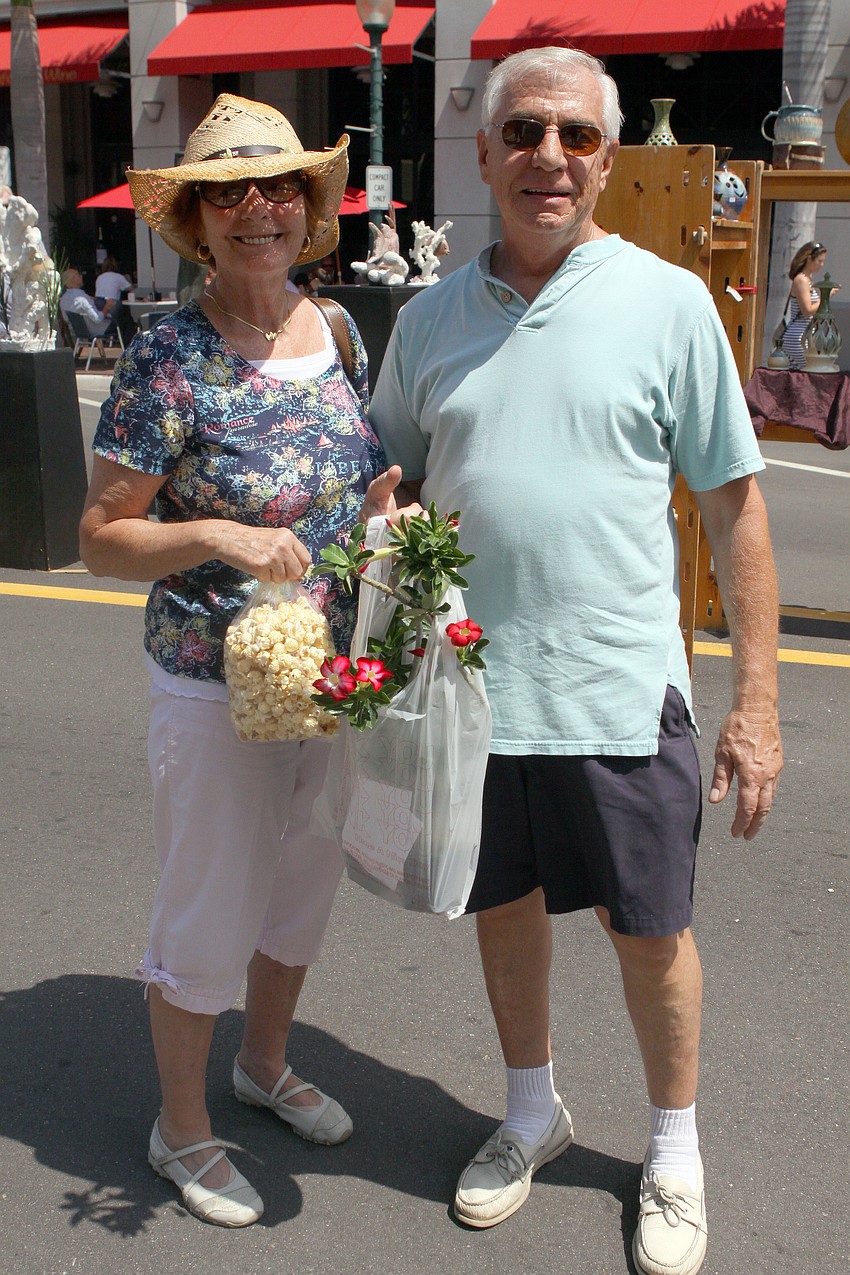 Doris and Roy Muller show off the things they bought at the Craft Festival Sunday, May 22 along Main Street and in Five Points Park.