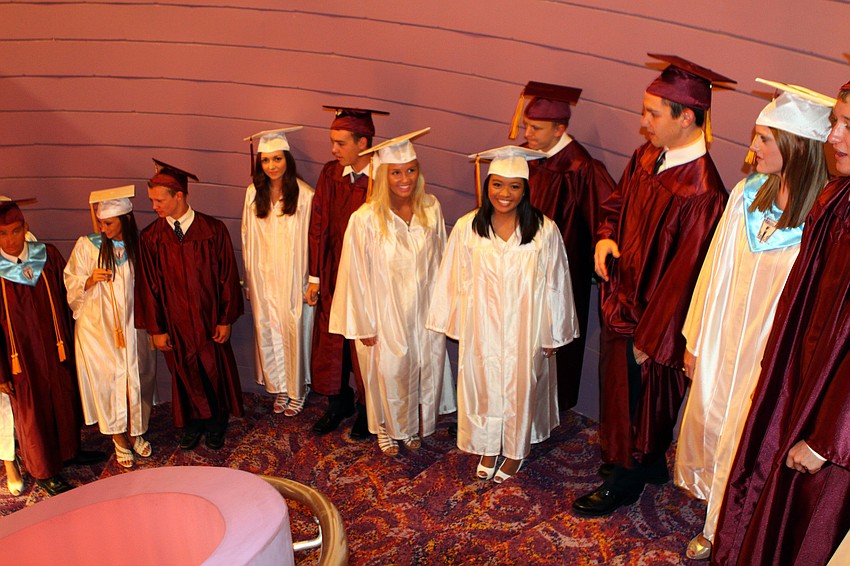 Students line up on the spiral staircase and wait to be told to begin walking in for their graduation ceremony Friday, May 27 at the Van Wezel Performing Arts Hall.