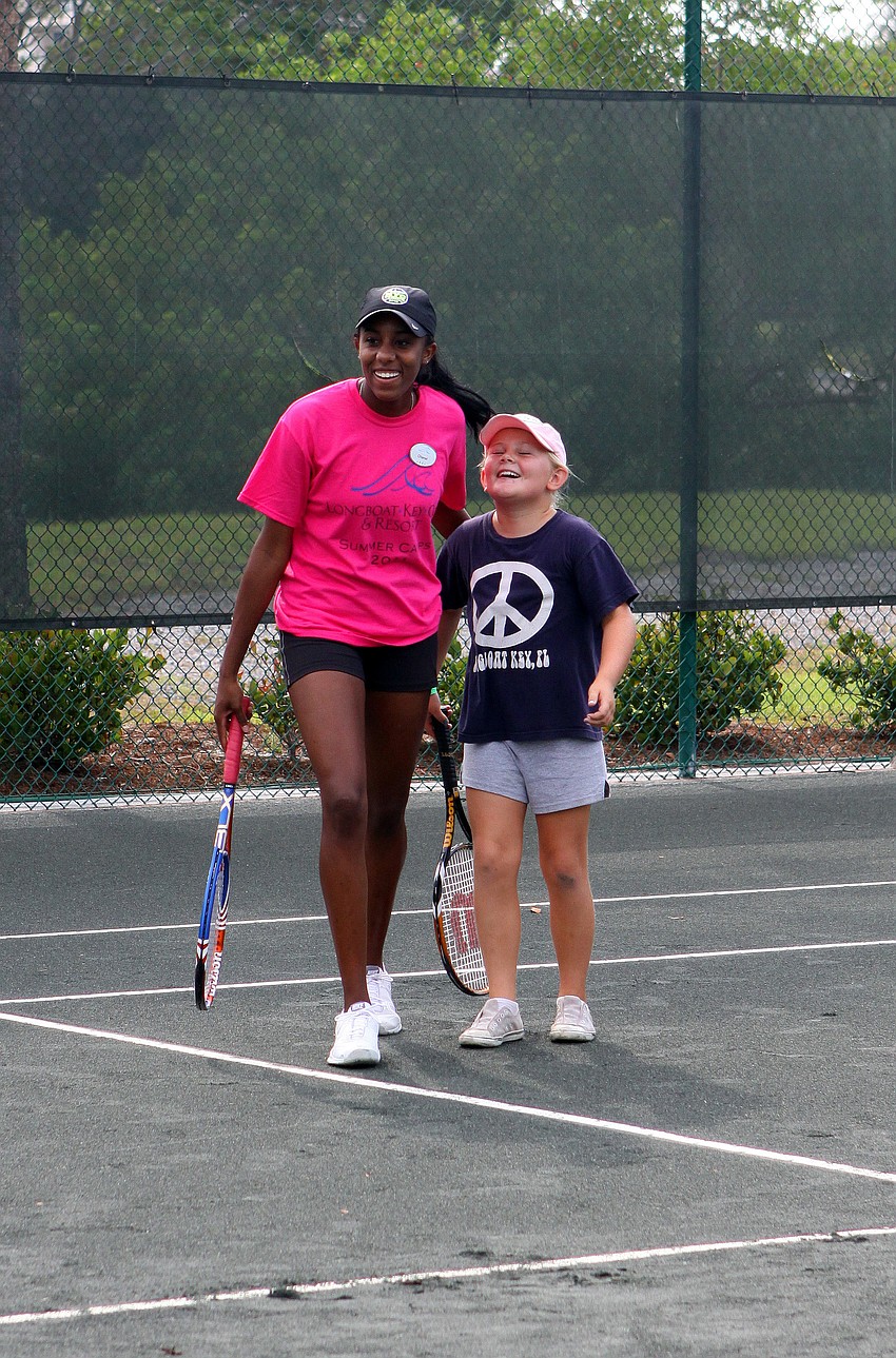 Chanel Glasper and Averie Robinson, 9, laugh it up on the court during Longboat Key Club's Tennis Camp Monday, June 6 at Longboat Key Club's Tennis Gardens.